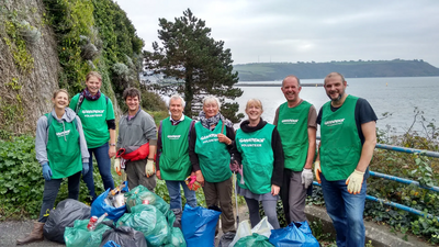 Plymouth Lib Dem chair Hugh Janes (4th from left) joins clean up on The Hoe